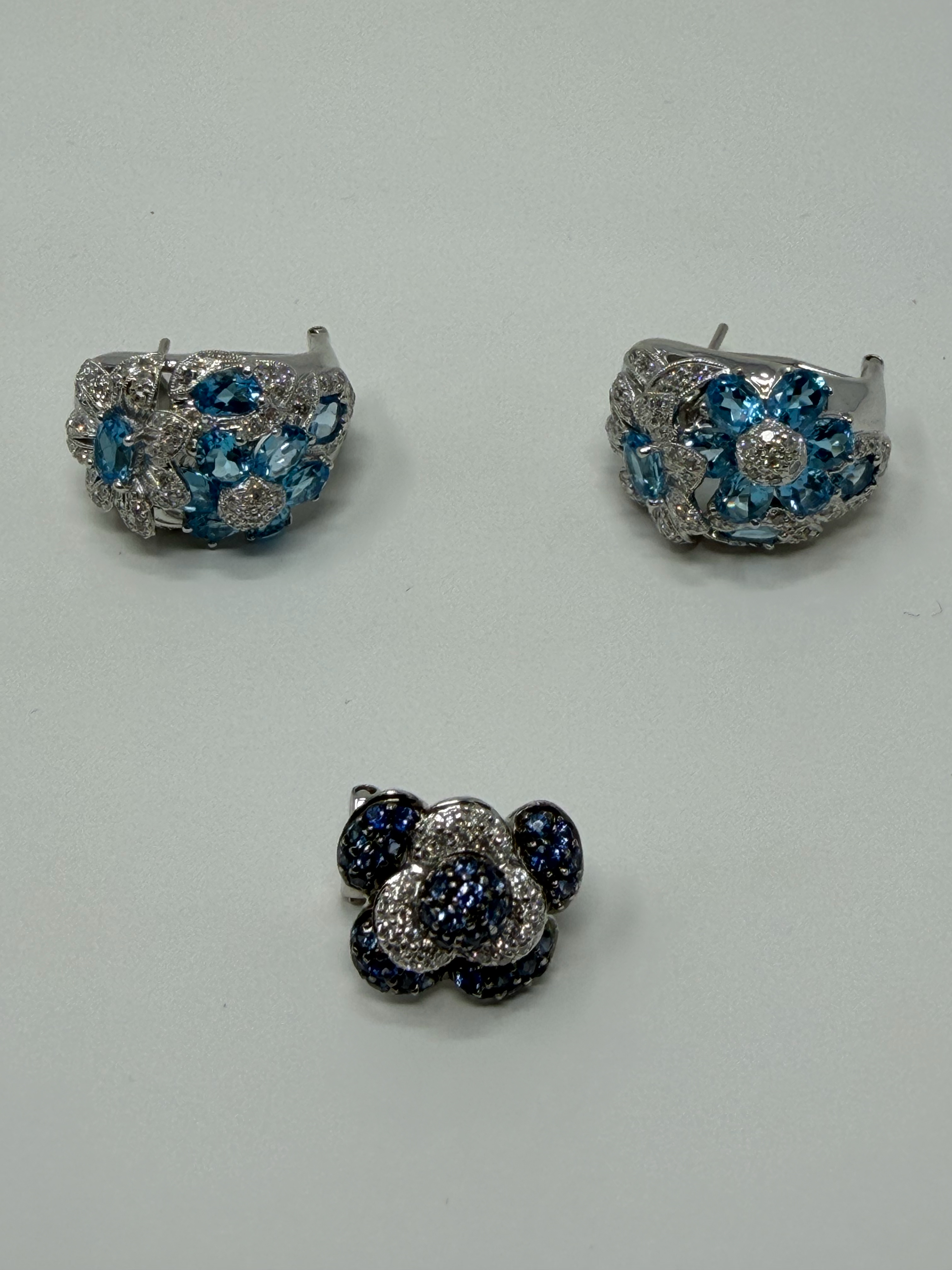Blue topaz and diamond cluster earrings with sapphire flower ring